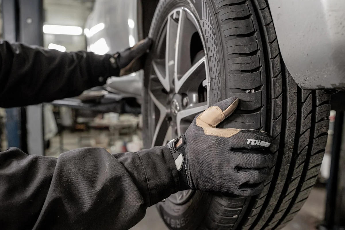 Technician fitting a car tyre